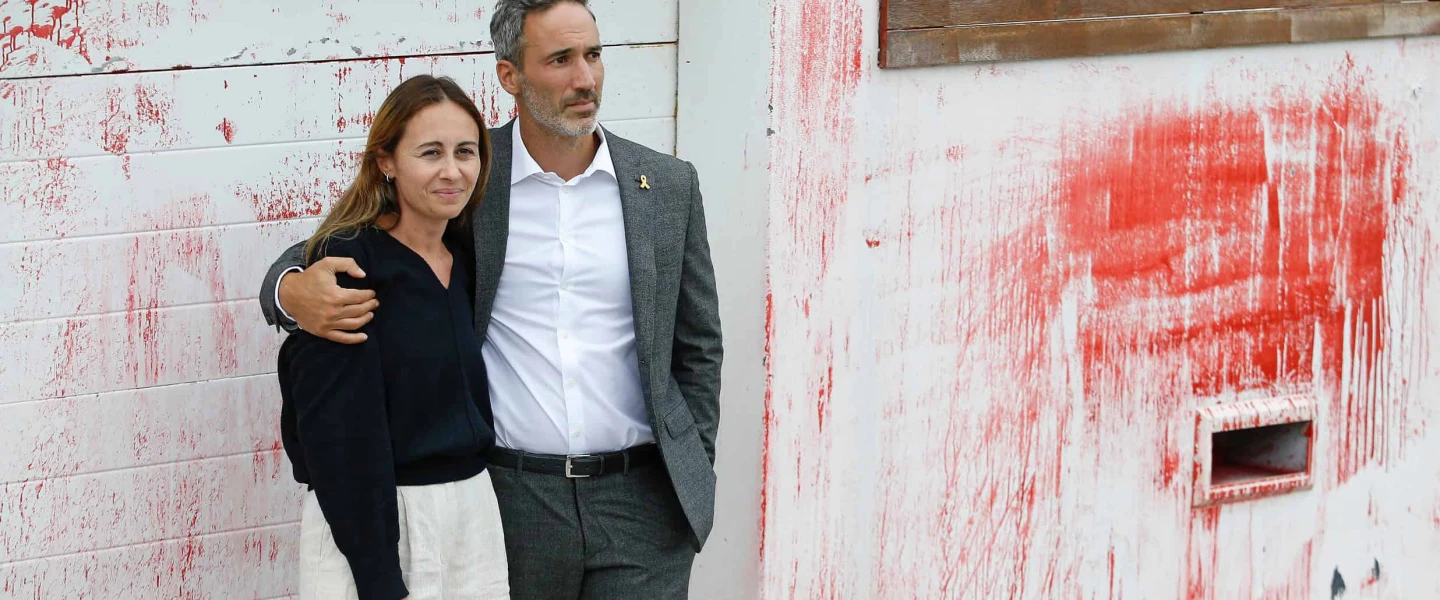 Alex and Vicki Ryvchin stand outside their vandalized former home in Sydney in January. Credit: Courtesy of Alex Ryvchin.