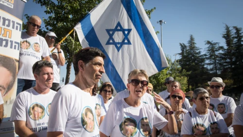 The parents of captured IDF soldier Hadar Goldin and other family members and supporters gather outside the state memorial ceremony for "Operation Protective Edge" at Mount Herzl in Jerusalem on July 23, 2019. Photo by Noam Revkin Fenton/Flash90.