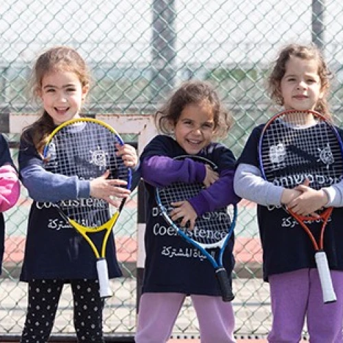 Players from the Israel Tennis & Education Centers wear coexistence-themed shirts. Credit: Israel Tennis & Education Centers.