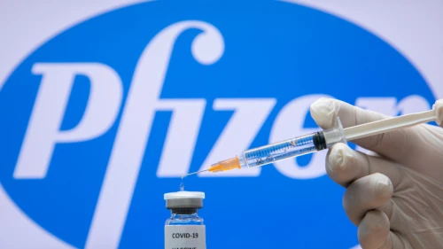 A photo illustration of a syringe and and a bottle reading "COVID-19 Vaccine" next to the Pfizer company logo in Jerusalem on Dec. 10, 2020. Photo by Olivier Fitoussi/Flash90.