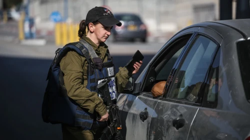 An Israeli soldier from the Erez Battalion in the Military Police checks IDs and Palestinian vehicles at the checkpoint to the Shuafat Refugee Camp in eastern Jerusalem on Dec. 22, 2015. Credit: Hadas Parush/Flash90.