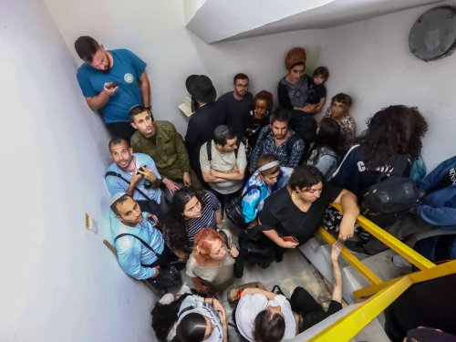 Israelis take cover inside a bomb shelter at Ben-Gurion International Airport as a siren alert is sounded, Oct. 1, 2024. Photo by Dor Pazuelo/Flash90.