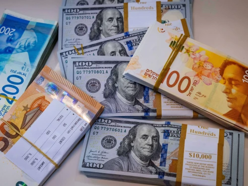 Illustration of American 100 dollar bills, 100 and 200 shekel bills and 50 euro bills, May 19, 2025. Photo by Nati Shohat/Flash90.