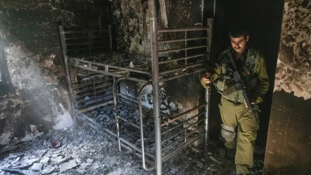 An Israeli soldier surveys the aftermath of Hamas's Oct. 7 massacre in Kibbutz Nir Oz, Oct. 30, 2023. Photo by Chaim Goldberg/Flash90.