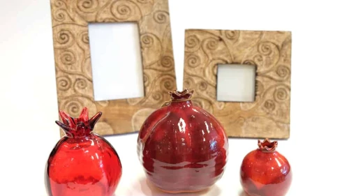 Glass pomegranates and hand-carved frames made in India. Credit: Dayenu.