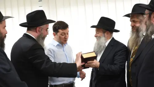 President-elect Volodymyr Zelenskyy, Ukraine's first-ever Jewish president, held a high-profile meeting with Ukraine's regional chief rabbis on May 6. Here, the comedian-turned-politician is presented with a Chumash in Russian translation by Rabbi Shmuel Kaminezki and Rabbi Avraham Wolff, as other members of the delegation look on. Credit: Chabad.org/News.