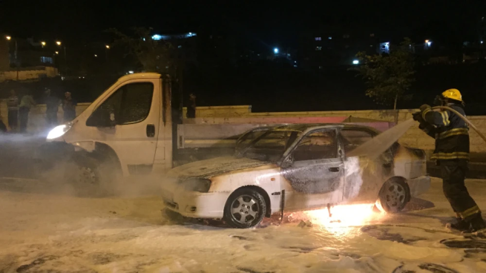 Firefighters extinguish a fire caused by a firebombing near the Arab neighborhood of Beit Hanina in eastern Jerusalem. Two people were injured in the attack, one woman was evacuated to Hadassah Medical center with severe burns. August 3, 2015. Photo by Sliman Khader/Flash90.