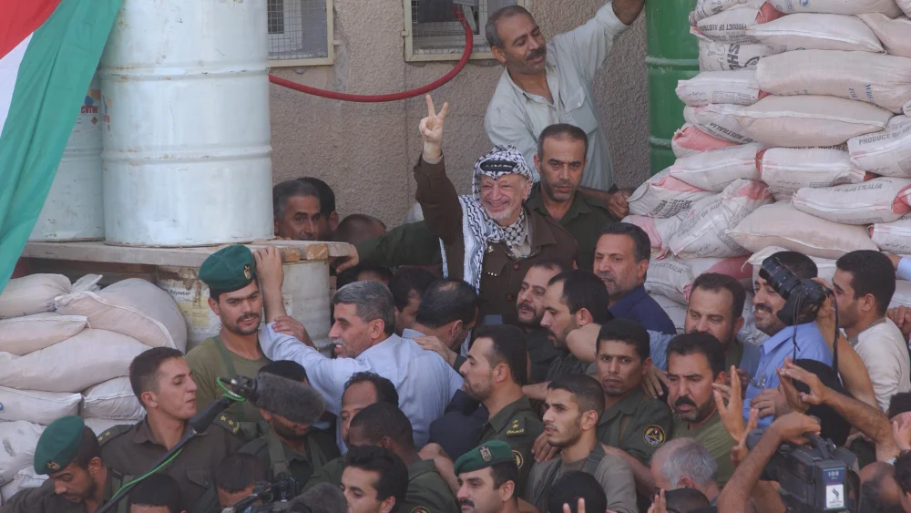 After the retreat of the Israeli army, former Palestinian leader Yasser Arafat leaves his compound where he spent a few months in detention, Sept. 29, 2002. Photo by Flash90.
