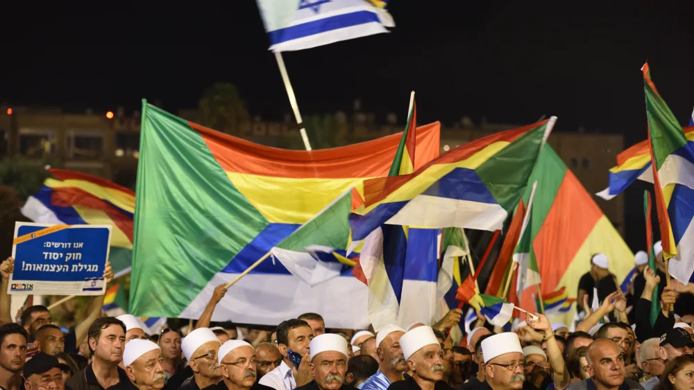 Israeli Druze attend a Druze-led rally to protest against the 'Jewish Nation-State law' in Rabin Square, Tel Aviv on Aug. 04, 2018. Tens of thousands of Israeli Druze and their supporters gathered in Tel Aviv on Saturday night to protest against the 'Jewish Nation-State' law. Photo by Gili Yaari /FLASH90