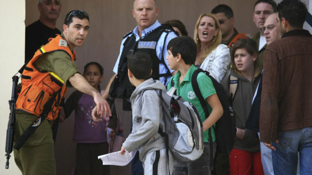Click photo to download. Caption: Students are evacuated from a school in the southern Israeli city of Sderot in November 2009 after a Qassam rocket hit the building. Photo by Nati Shohat/Flash90.