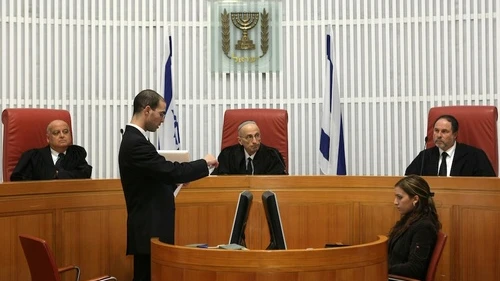 In center is retired Israeli Supreme Court judge Edmond Levy, who is now in the news for heading the Commission to Examine the Status of Building in Judea and Samaria. Credit: Kobi Gideon/Flash90.