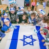Israeli children wave Israeli flags ahead of the country's 73rd Independence Day, at a kindergarten in Moshav Yashresh, April 13, 2021. Photo by Yossi Aloni/Flash90.
