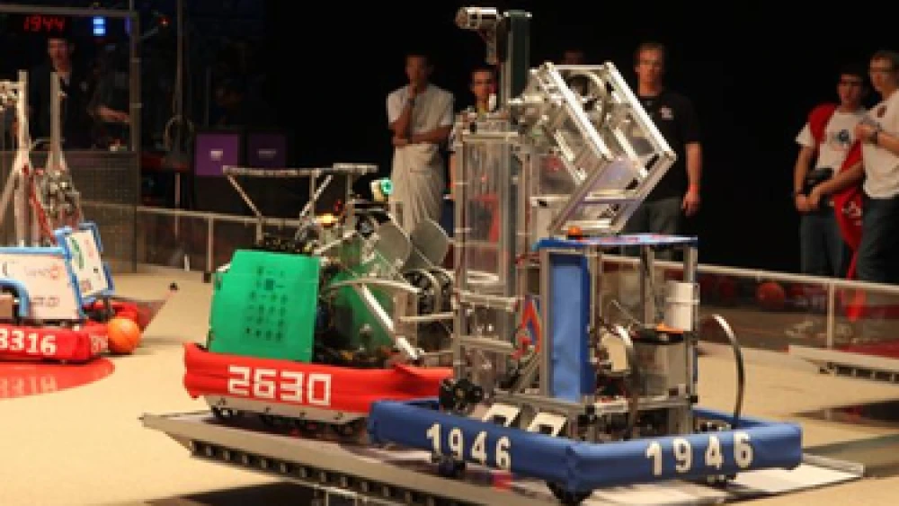 Click photo to download. Caption: Basketball-playing robots squared off on a custom-sized court at the FIRST competition in Tel Aviv. Robotics technology is among Israel's various technological accomplishments at 65, in addition to the stability of the Israeli economy. Credit: FIRST Israel/Avishai Finkelstein.