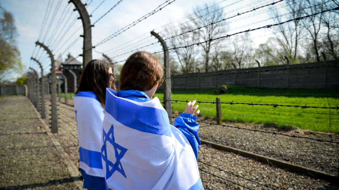 Jewish youngsters in Poland to participate in the annual March of the Living gaze into the Auschwitz-Birkenau camp site, April 16, 2015. Credit: Yossi Zeliger/Flash90.