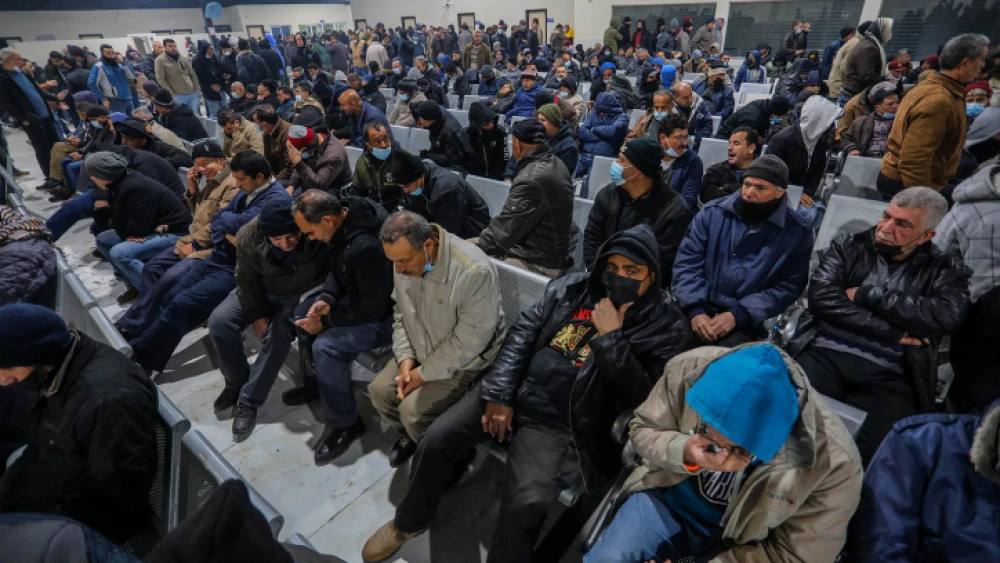 Palestinian workers at the Erez border crossing in Beit Hanun in the northern Gaza Strip as they wait to enter Israel for work on March 13, 2022. Photo by Attia Muhammed/Flash90.