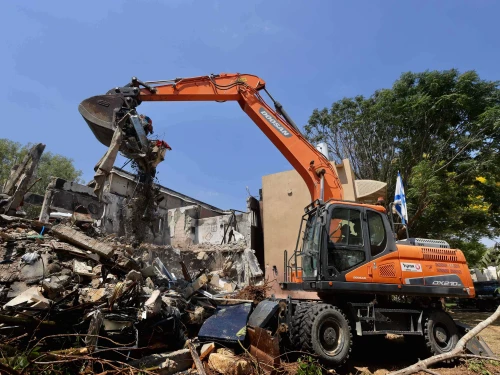 A bulldozer demolishes a house that was damaged during the Oct. 7 massacre in Kibbutz Be'eri, as part of a project to rebuild the destroyed homes and infrastructure in the kibbutz, July 7, 2024. Photo by Oren Cohen/Flash90.