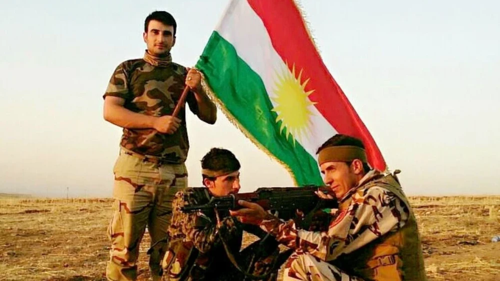 Combatientes kurdos despliegan su bandera. Crédito: Flickr.
