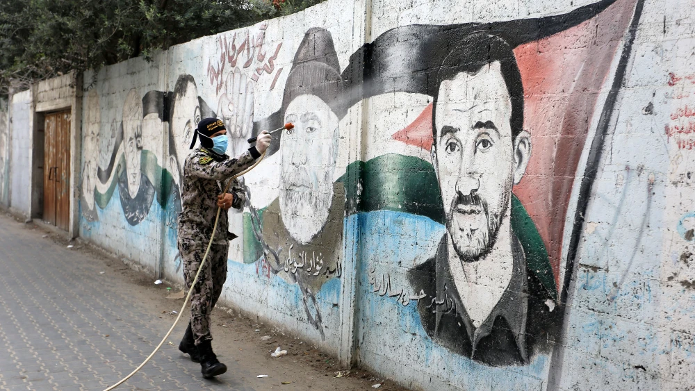 Members of the Palestinian Islamic Jihad's armed wing, the Al-Quds Brigades, spray disinfectant in the streets of Rafah in the southern Gaza Strip during a campaign aimed at slowing down the spread of the coronavirus, March 26, 2020. Photo by Abed Rahim Khatib/Flash90.