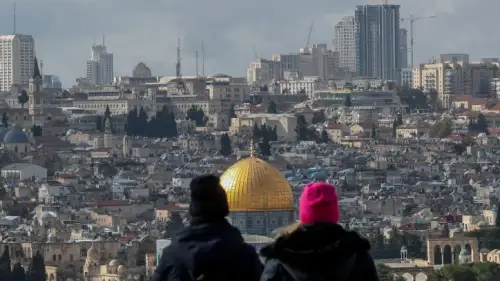 Tourists at a lookout point on the Mount of Olives gaze down on the Temple Mount and the Old City of Jerusalem, Feb. 8, 2023. Photo by Jamal Awad/Flash90.