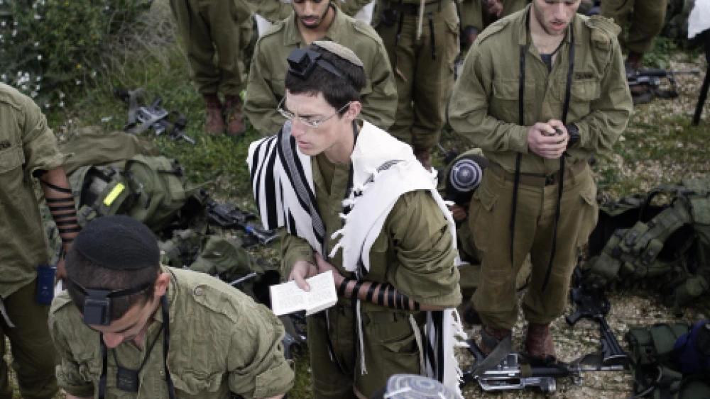 Israeli soldiers in the Neztah Yehuda Battalion (“Nahal Haredi”) complete the final stages of a 40-kilometer journey during the night on Feb. 16, 2010. Other military practices are being debated by a group of rabbis in Israel. Photo by Abir Sultan/Flash90.