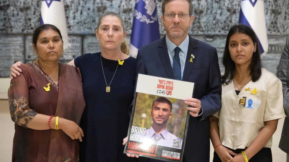 Israeli President Isaac Herzog and his wife, Michal Herzog, with a poster of hostage Bipin Joshi, who was taken hostage by Hamas on Oct. 7, 2023, as Padma Joshi (left) and Pushpa Joshi visit the President's Residence in Jerusalem, Aug. 17, 2025. Credit: Amos Ben Gershom/GPO.