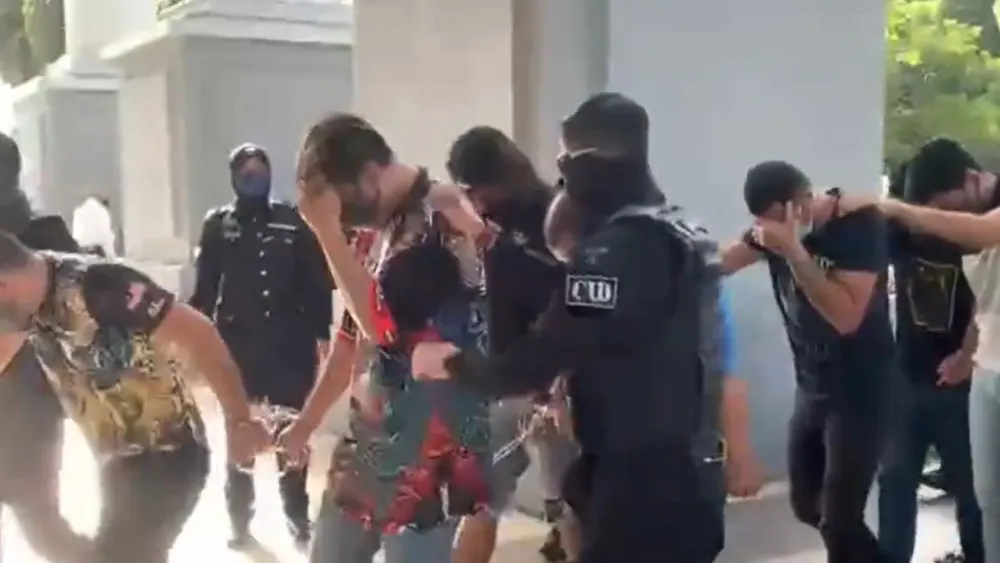 Men accused of membership in a Mossad ring are led into Kuala Lumpur Magistrate's Court, Oct. 14, 2022. Credit: Twitter.