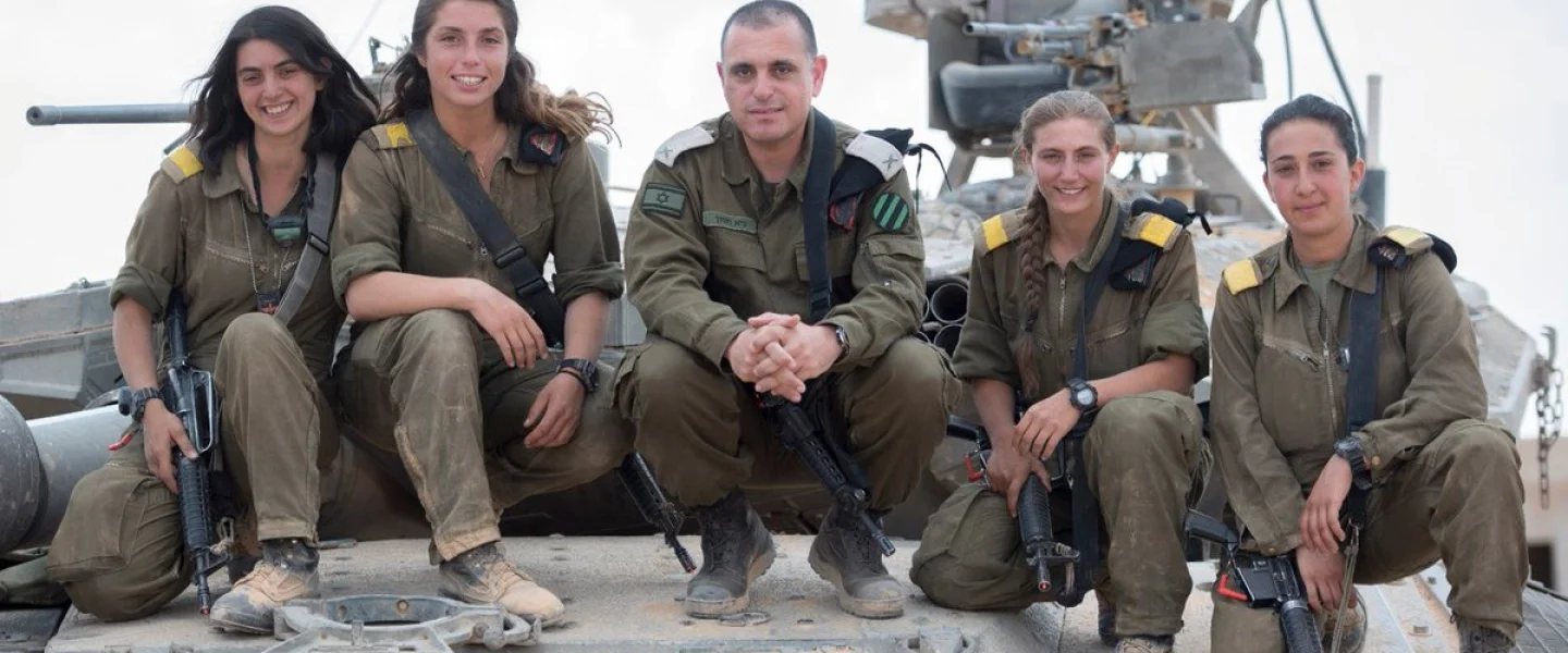 The first four female tank commanders in the Israel Defense Forces pose with Brig. Gen. Guy Hasson, head of the Armored Corps. Credit: IDF Spokesperson Unit.