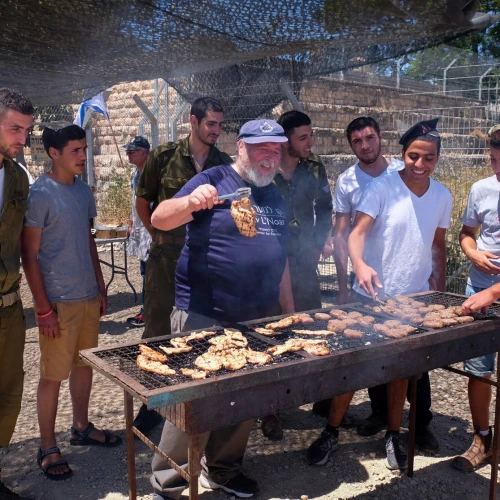 Israeli soldiers enjoy a barbecue prepared for them in honor of Israel's Independence Day in 2016 at the "soldiers corner," a place to rest and eat at the Gush Etzion junction. Credit: Gershon Elinson/Flash90.