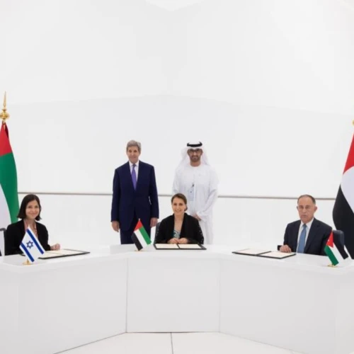 Israeli Energy and Water Resources Minister Karine Elharrar, UAE Climate Change Minister Mariam Almheiri and Jordan Water and Irrigation Minister Mohammed Al-Najjar sign a water agreement at the Dubai Expo on Nov. 22, 2021, as U.S. Climate Envoy John Kerry and UAE Crown Prince Mohammed bin Zayed look on. Credit: Israeli Foreign Ministry.