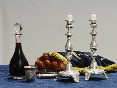 Illustration of a Shabbat table with the customary wine, challah and candles, which will all be blessed before the meal (photo was not taken on Shabbat). Photo by Mendy Hechtman/Flash90.