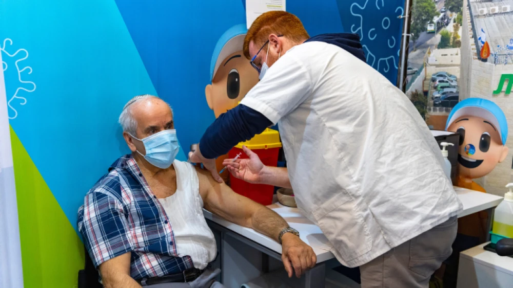 Adults over 60 receive a fourth dose of the COVID-19 vaccine at a Clallit vaccine center in Jerusalem on Jan. 3, 2022. Photo by Olivier Fitoussi/Flash90.