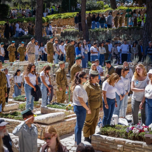 Israelis stand in silence next to the graves of soldiers in the Mount Herzl military cemetery in Jerusalem, as a two-minute siren sounds across the country on Memorial Day, April 25, 2023. Photo by Erik Marmor.