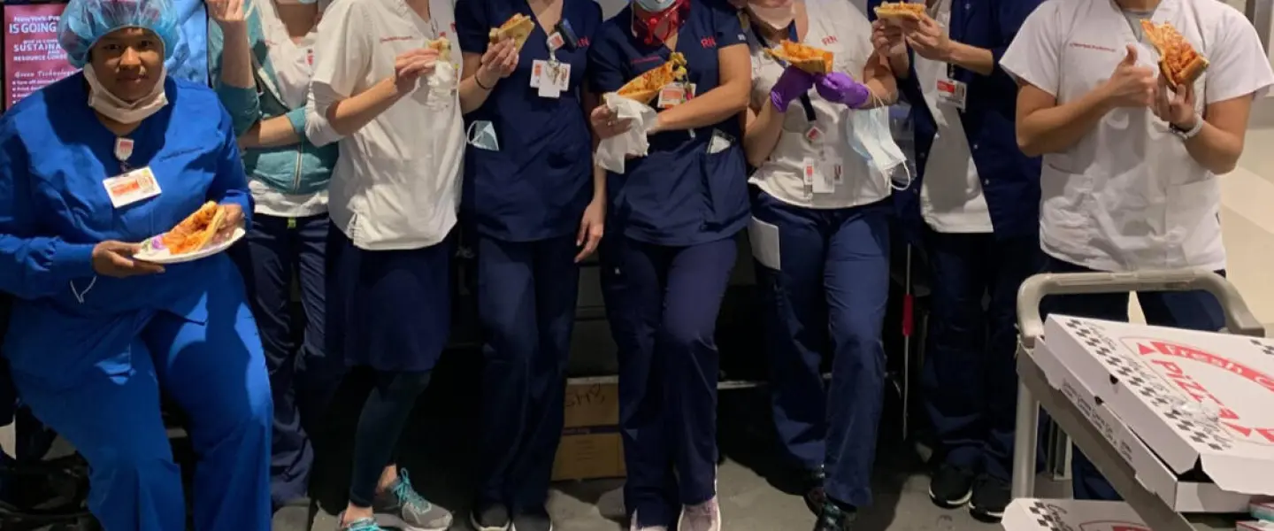 Health-care professionals at New York-Presbyterian Hospital enjoy kosher pizza delivered by Kosher19. Credit: Courtesy.