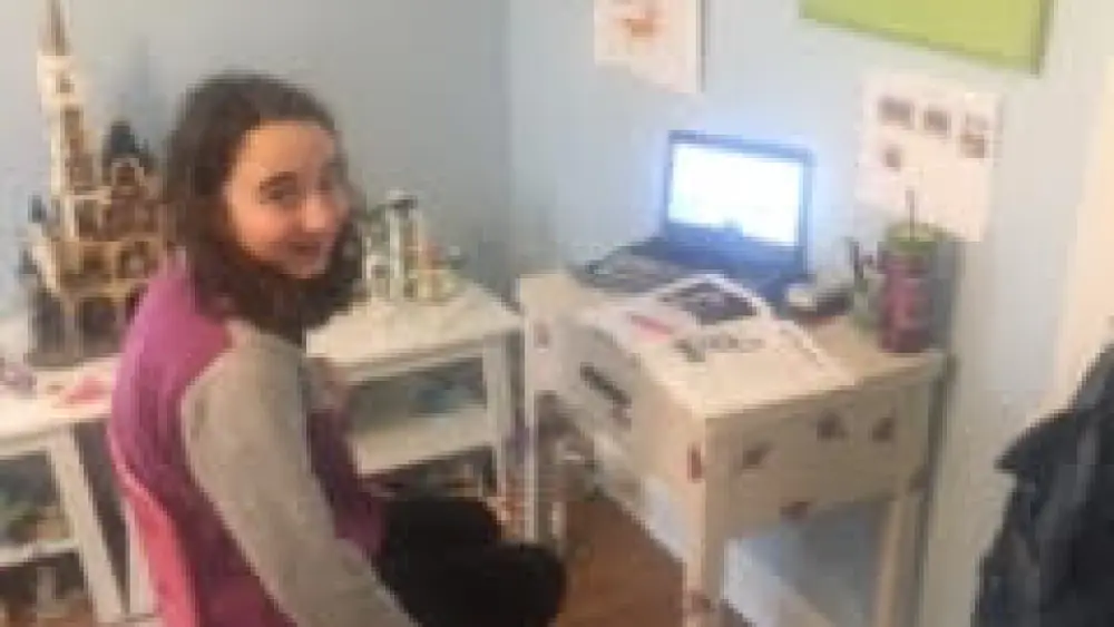 Ellie Kay, a sixth-grader at the Solomon Schechter Day School in West Hartford, Conn, is doing her learning and prayers online these days. Credit: Courtesy.