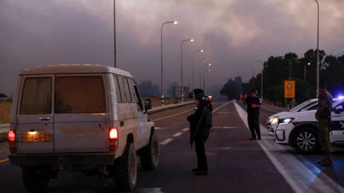 Police secure a road as smoke billows after rockets were fired from Southern Lebanon in the Golan Heights on July 9, 2024. Photo by Jalaa Marey/AFP via Getty Images.