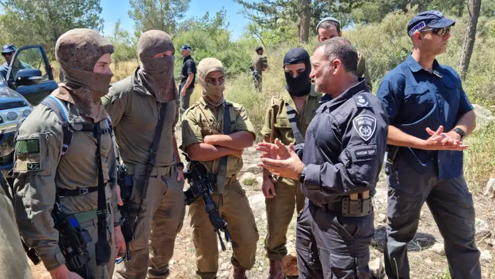 Israel Police Commissioner Yaakov Shabtai (second from right) talks with members of the Israeli forces participating in the search for the terrorists who murdered three people in the city of Elad on May 5, 2022, in this image posted on social media on May 8, 2022. Source: Israel Police Twitter.