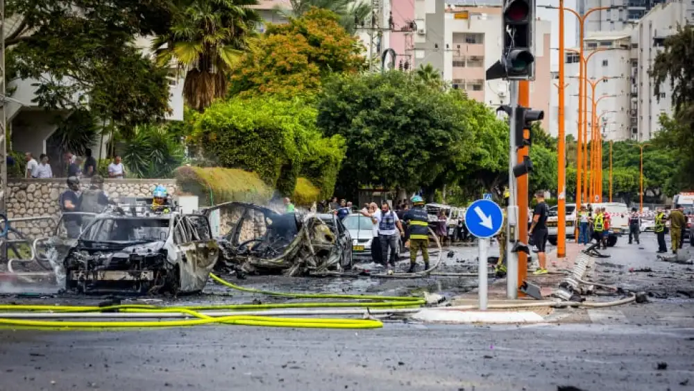 Security and rescue personnel at the scene where a Gazan rocket hit apartment buildings and cars in Ashdod on Oct. 9, 2023. Photo by Liron Moldovan/Flash90.