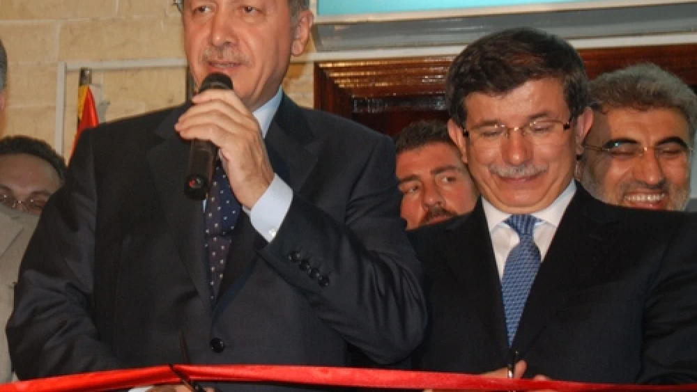 Pictured in front at a ribbon-cutting ceremony are Turkish Presdient Recep Tayyip Erdoğan (left) and Turkish Prime Minister Ahmet Davutoğlu. On May 22, 2017, Davutoğlu will resign from his post. Credit: Kahire Yunus Emre Enstitüsü via Wikimedia Commons.