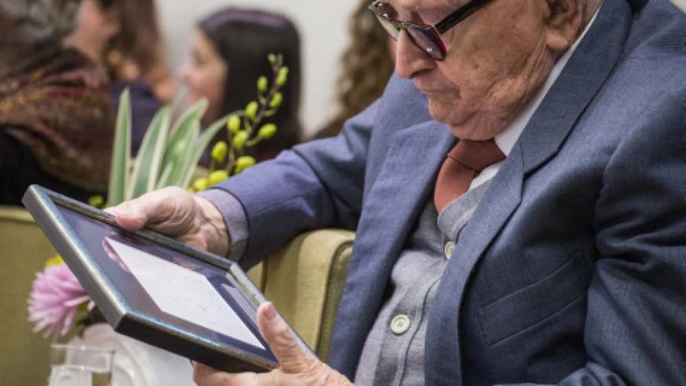 Rafi Eitan reviews a framed copy of the opening statement of main prosecutor Gideon Houzner from the world-famous Eichmann trial, which took place in Jerusalem in 1961. Israeli President Reuven Rivlin hosted an event President’s residence in Jerusalem marking the 55th anniversary of the trial on the International Holocaust Remembrance Day, Jan. 27, 2016. Photo by Hadas Parush/Flash90.