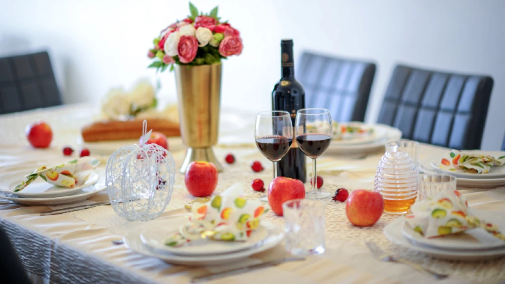 A table set for a traditional Rosh Hashanah meal in Israel, Sept. 10, 2017. Photo by Mendy Hachtman/Flash90.