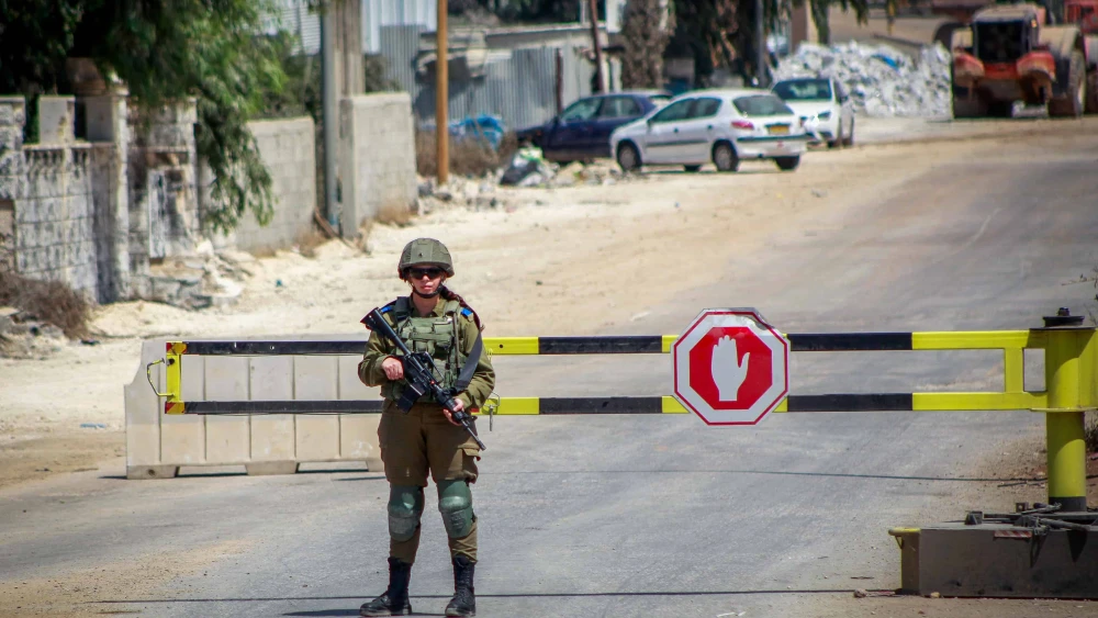 Israeli soldiers block the entrance to the village of Beita in northern Samaria during searches for the terrorist who carried out an attack in Huwara, on Aug. 20, 2023. Photo by Nasser Ishtayeh/Flash90.