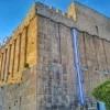 Israel flags decorate the 2,000-year-old Cave of the Patriarchs complex in Hebron in anticipation of Independence Day, May 2018. The same Herodian masonry is used for the Western Wall in Jerusalem. Photo by Yishai Fleisher.