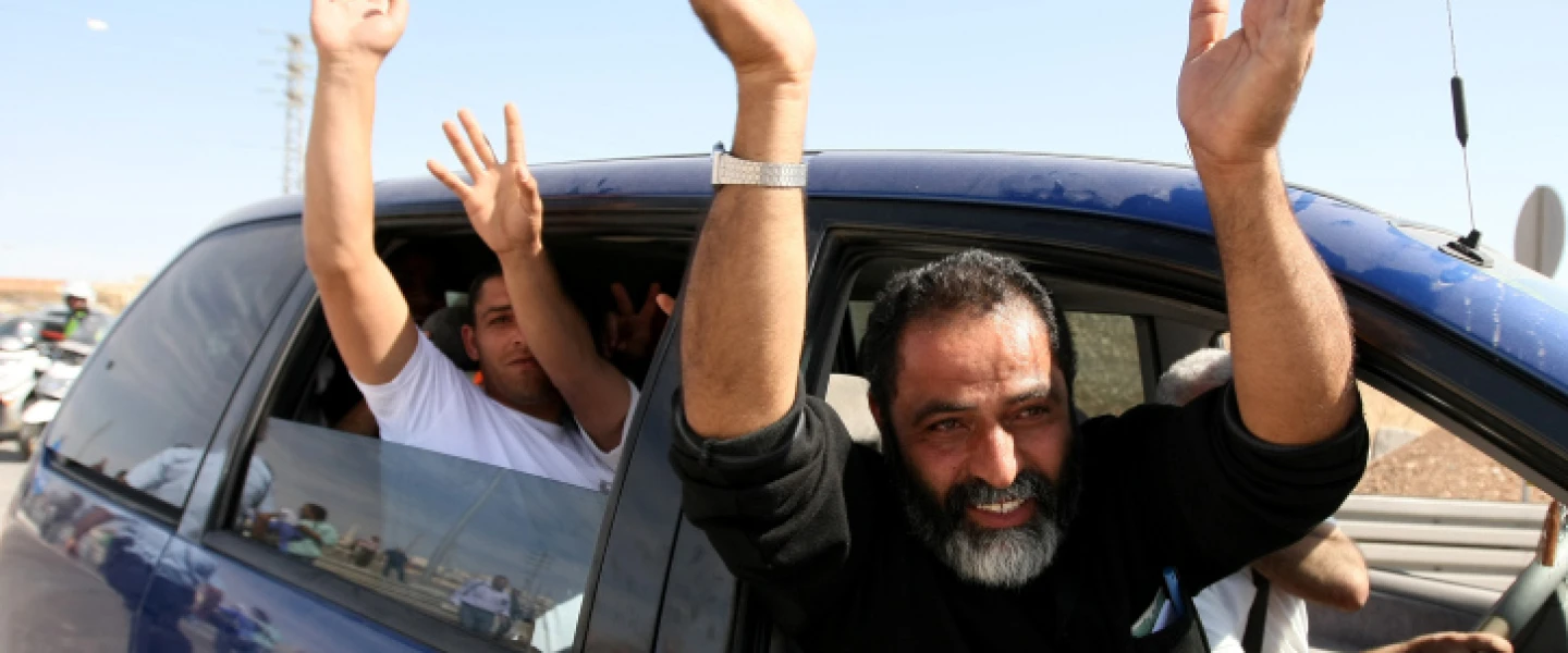 Palestinian terrorists released from Israeli jails, as part of the swap between Israel and Hamas for captive Gilad Shalit, wave as they leave a military base outside Jerusalem, Oct 18, 2011. Photo by Kobi Gideon/Flash90.