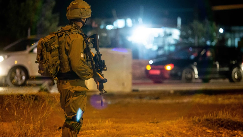 Israeli troops stand near the scene of a suspected car-ramming attack at the entrance to the village of Husan in Judea, June 23, 2018. Photo by Aharon Krohn/Flash90.