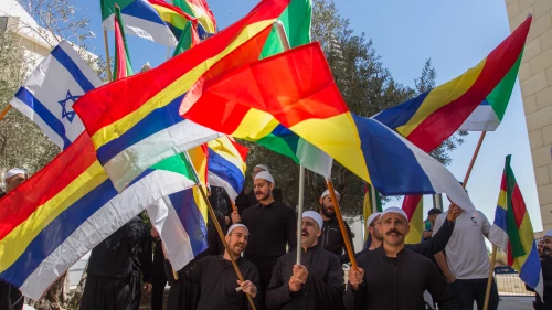 Druze men protest outside the Hafia District Court, carrying both the Druze and the Israeli flags. Photo by Flash90.