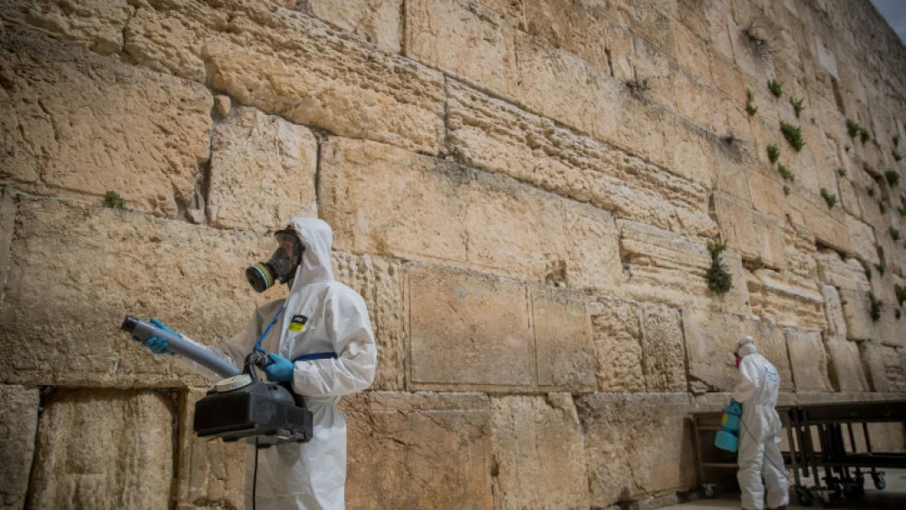 Israeli workers disinfect the Western Wall in the Old City of Jerusalem as a preventive measure against the spread of the COVID-19 virus, March 31, 2020. Photo by Yonatan Sindel/Flash90.