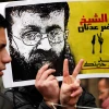 Palestinian protesters outside the Red Cross building in eastern Jerusalem hold placards in support of hunger-striking Islamic Jihad terrorist Khader Adnan, Feb. 10, 2023. Photo by Sliman Khader/Flash90.