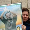A Palestinian woman holds a portrait of Palestinian terrorist prisoner Marwan Barghouti during a rally in Ramallah, the headquarters of the Palestinian Authority, on March 27, 2012. Credit: Issam Rimawi/Flash90.