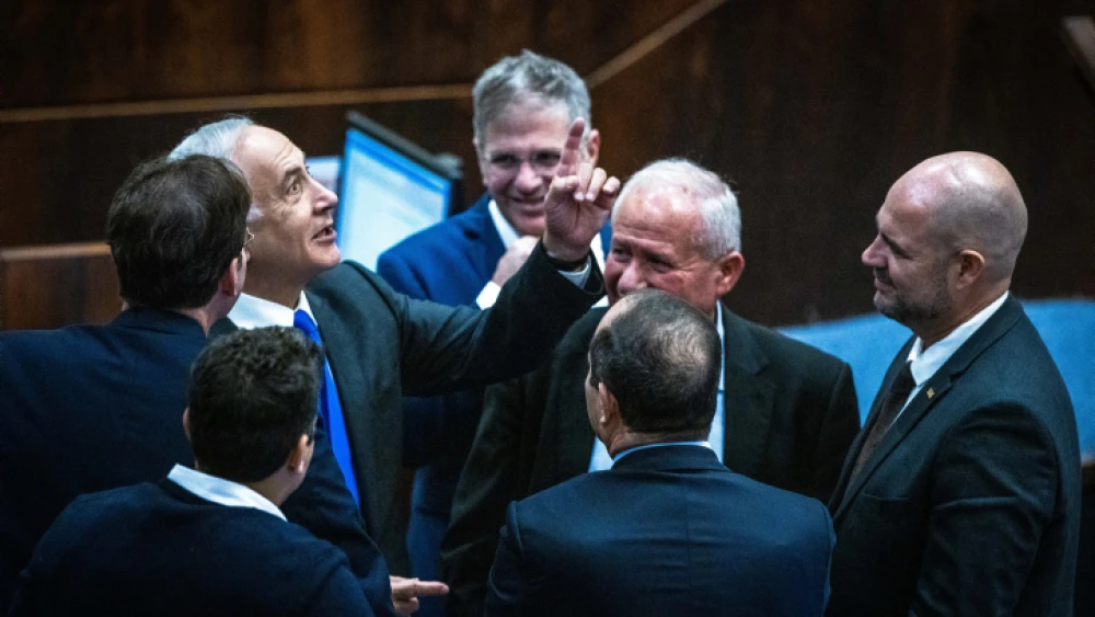 Likud leader Benjamin Netanyahu speaks with Likud MKs during a Knesset vote, Dec. 28, 2022. Photo by Olivier Fitoussi/Flash90.