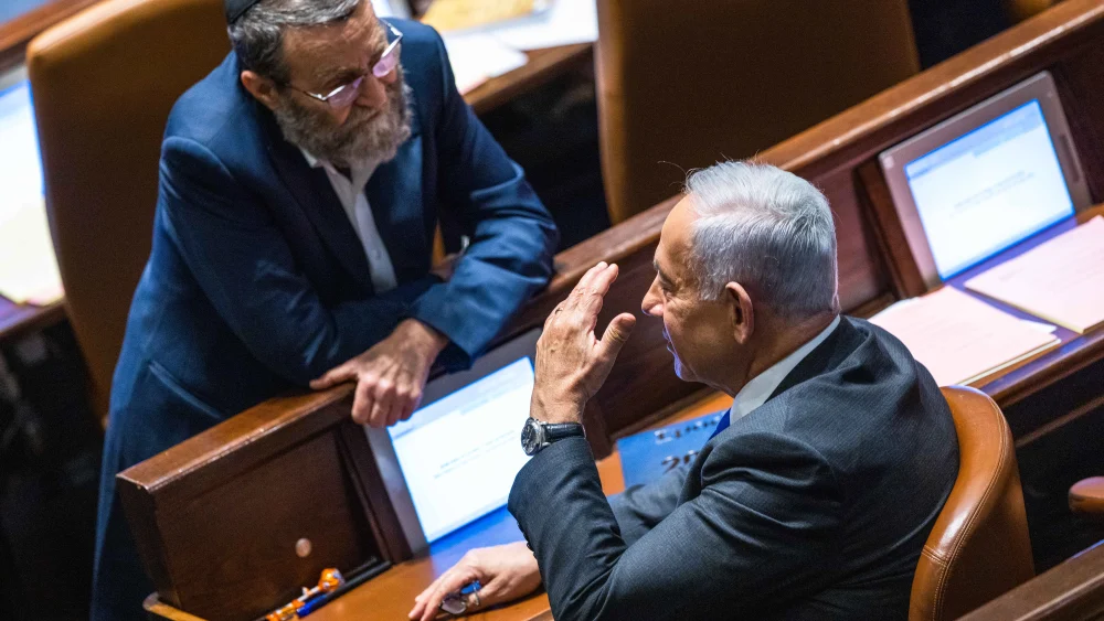 Likud Party leader Benjamin Netanyahu speaks with Degel HaTorah lawmaker Moshe Gafni during a vote in the assembly hall of the Knesset, the Israeli parliament in Jerusalem, Dec. 28, 2022. Photo by Olivier Fitoussi/Flash90.
